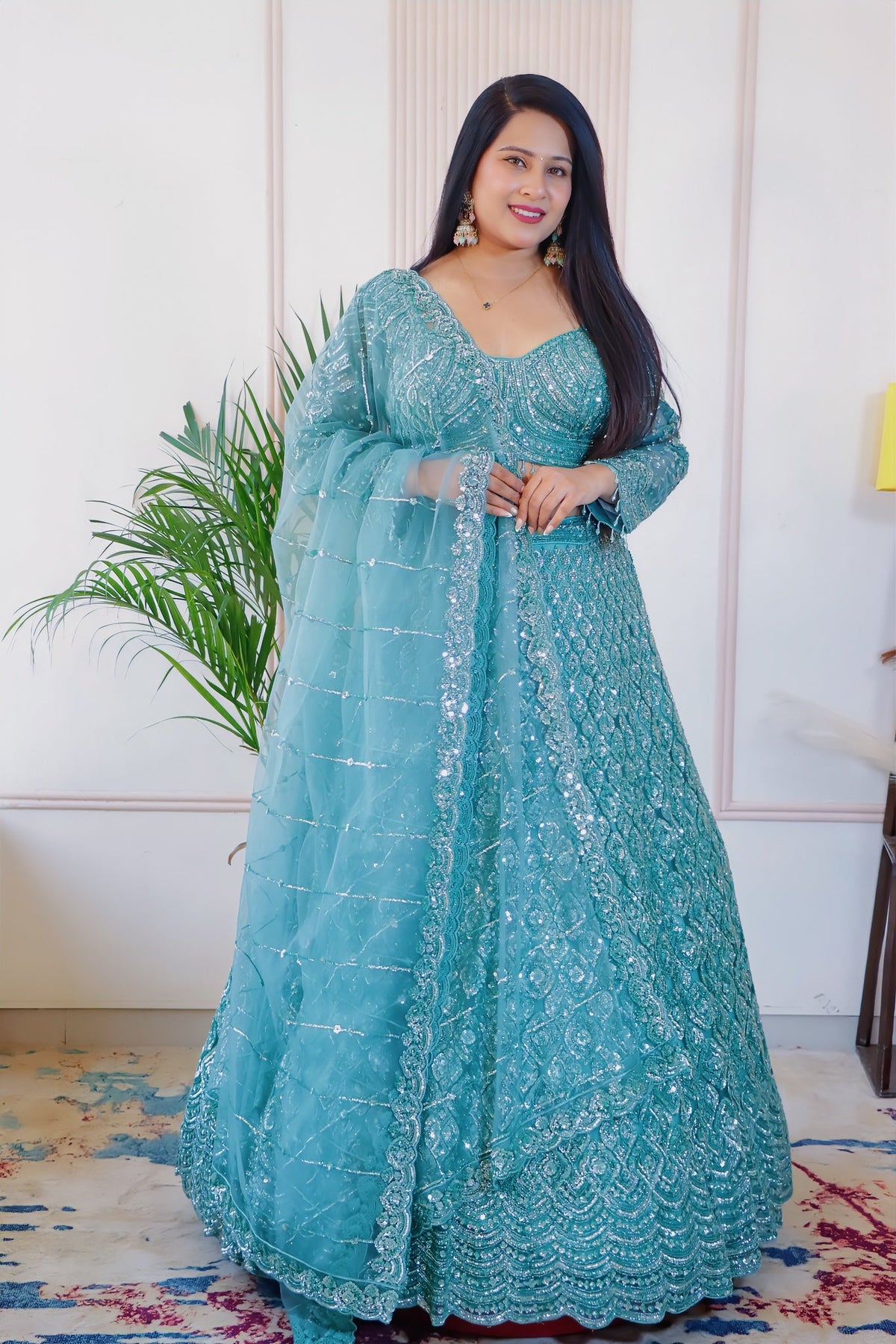 Teal green net lehenga from House of Daisy