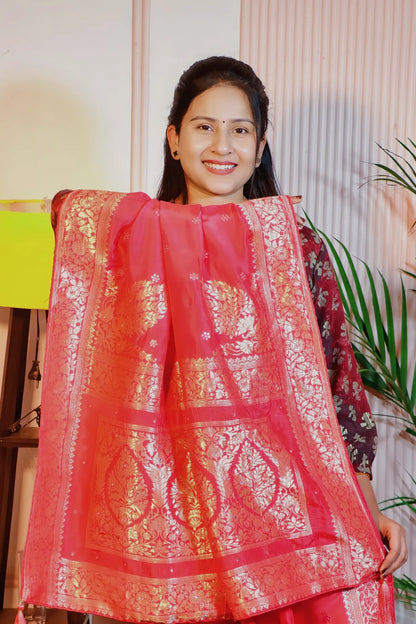Peach pink silk zari saree, pallu held open to show the zari weave