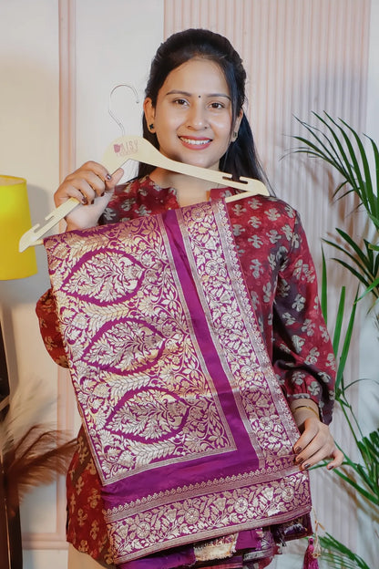 Royal purple silk saree, folded on a hanger to show the zari weave