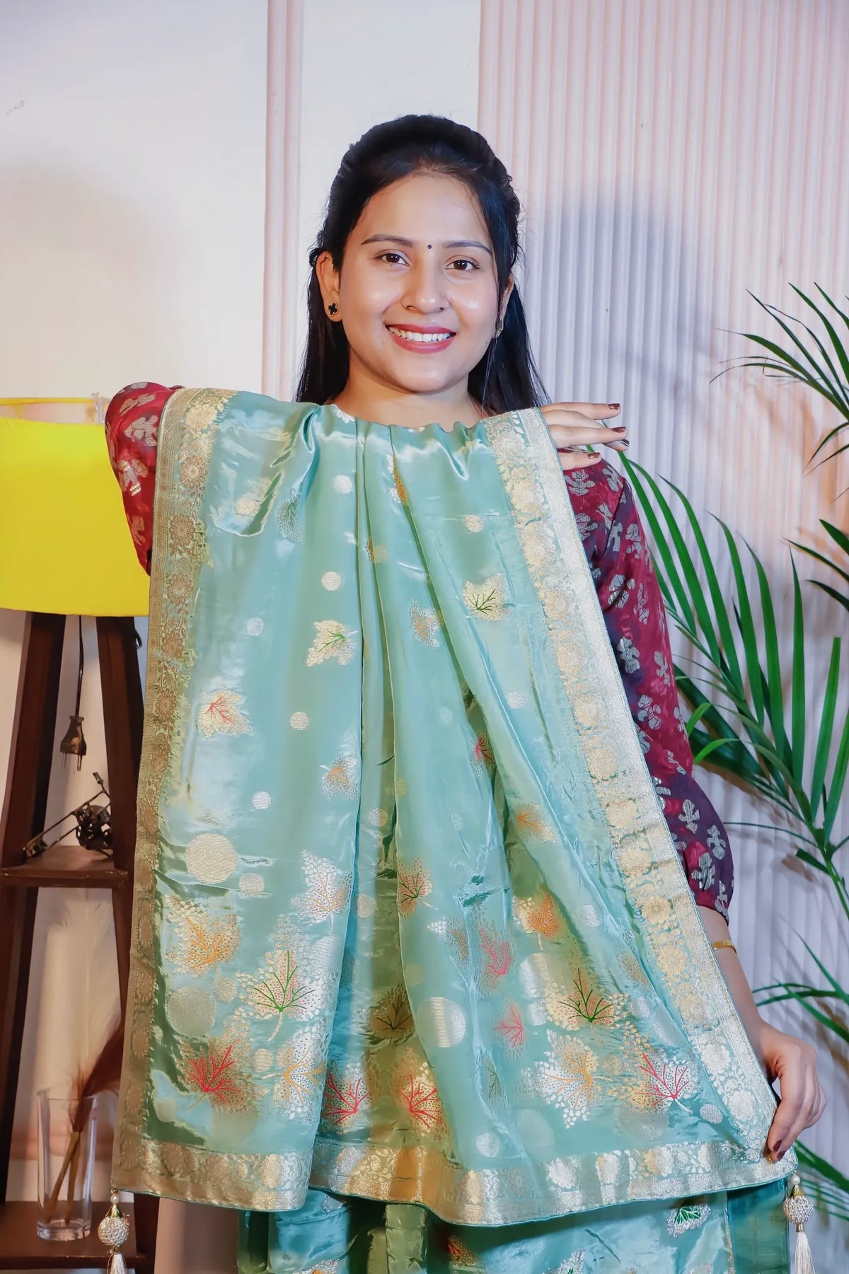 Pista green silk saree, pallu held open to show the weave