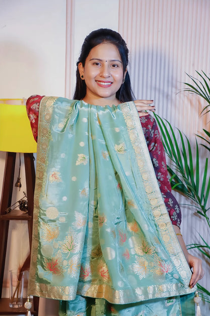 Pista green silk saree, pallu held open to show the weave