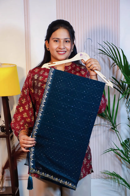 Navy blue georgette saree, folded on a hanger