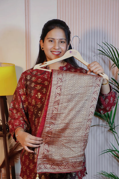 Maroon georgette saree, folded on a hanger