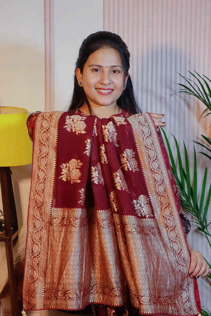 Maroon georgette saree, pallu held open to show the zari weave