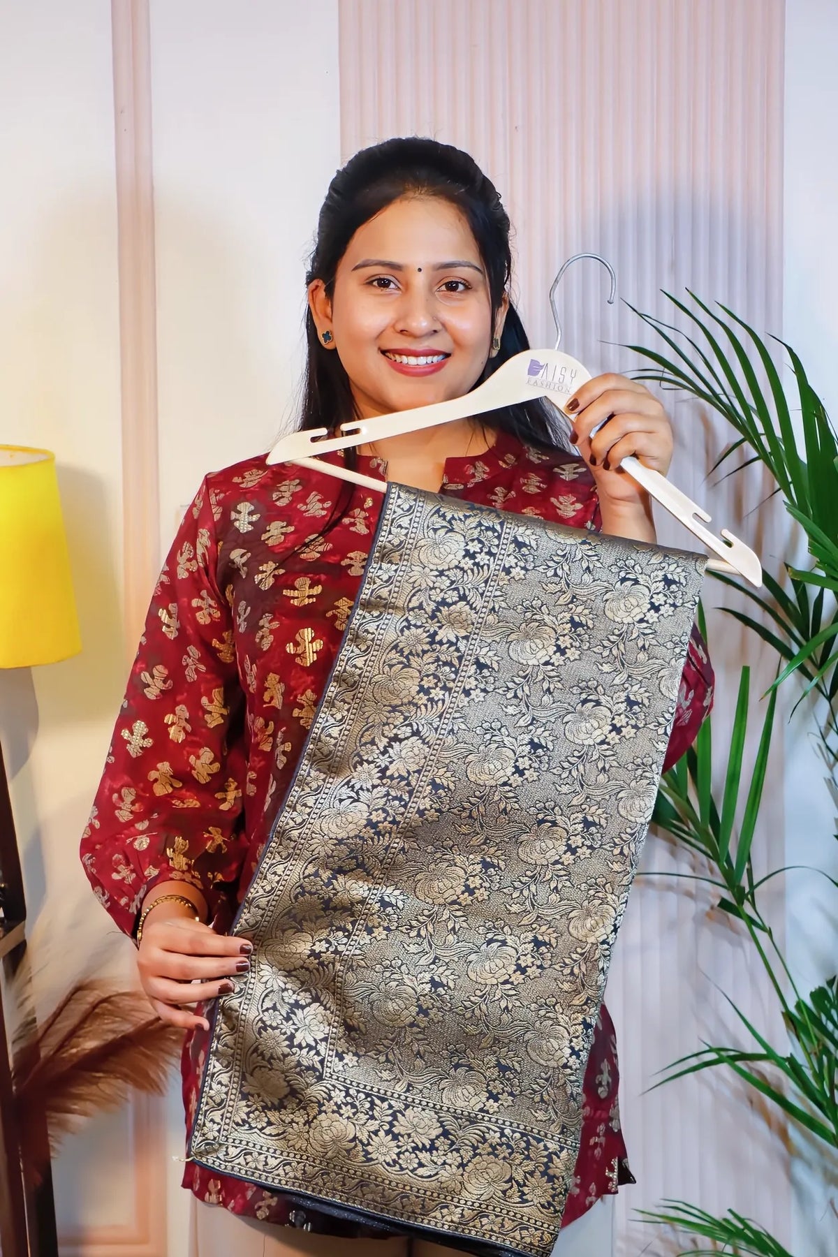 Grey silk saree, folded on a hanger to show the woven pattern