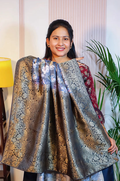 Grey silk saree, pallu held open to show the zari weave