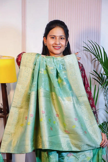 Mint green silk saree, pallu held open to show the zari weave