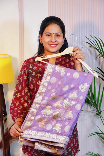 Purple silk saree, folded on a hanger to show the zari motifs