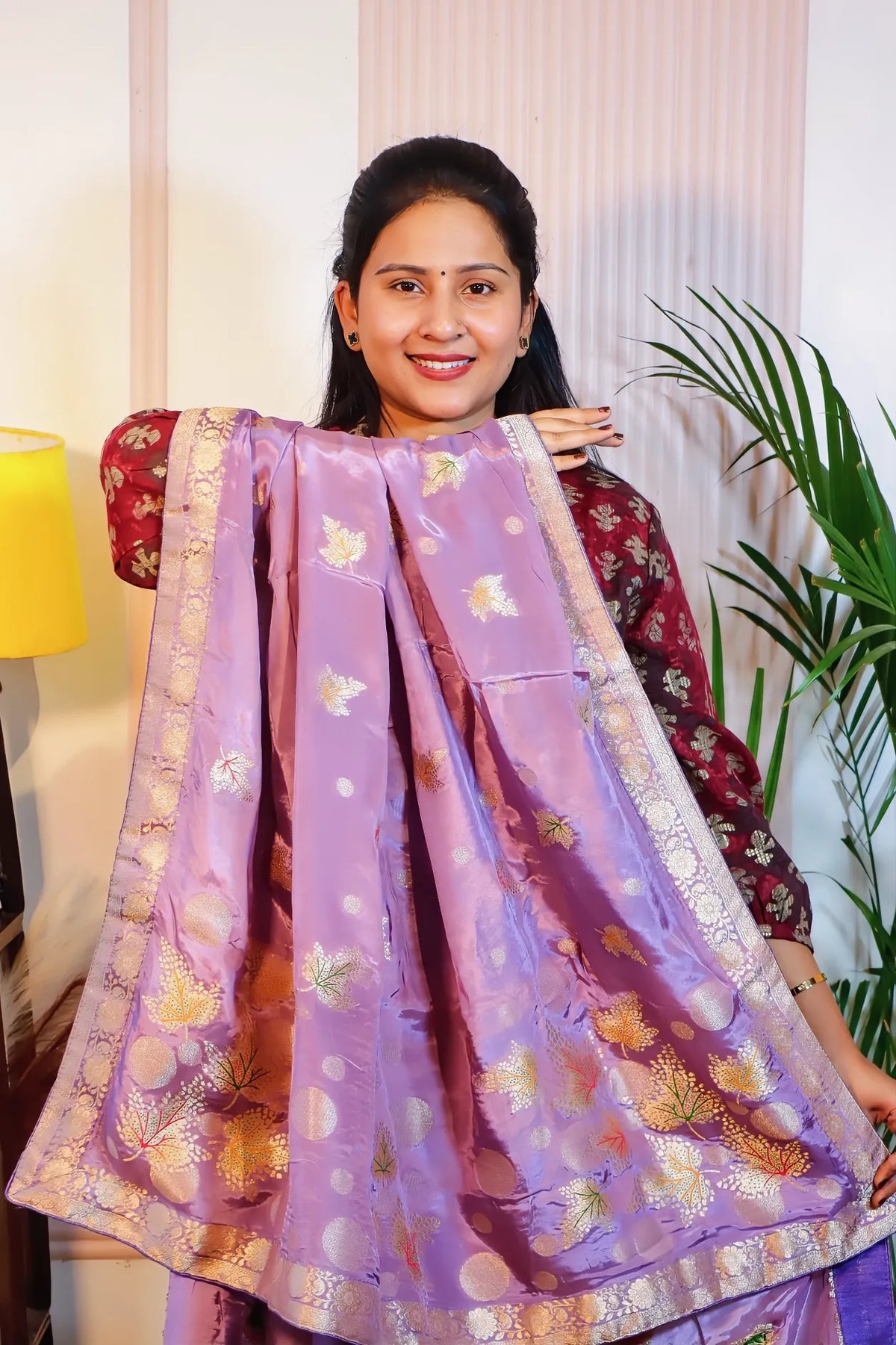 Purple silk saree, pallu held open to show the zari weave