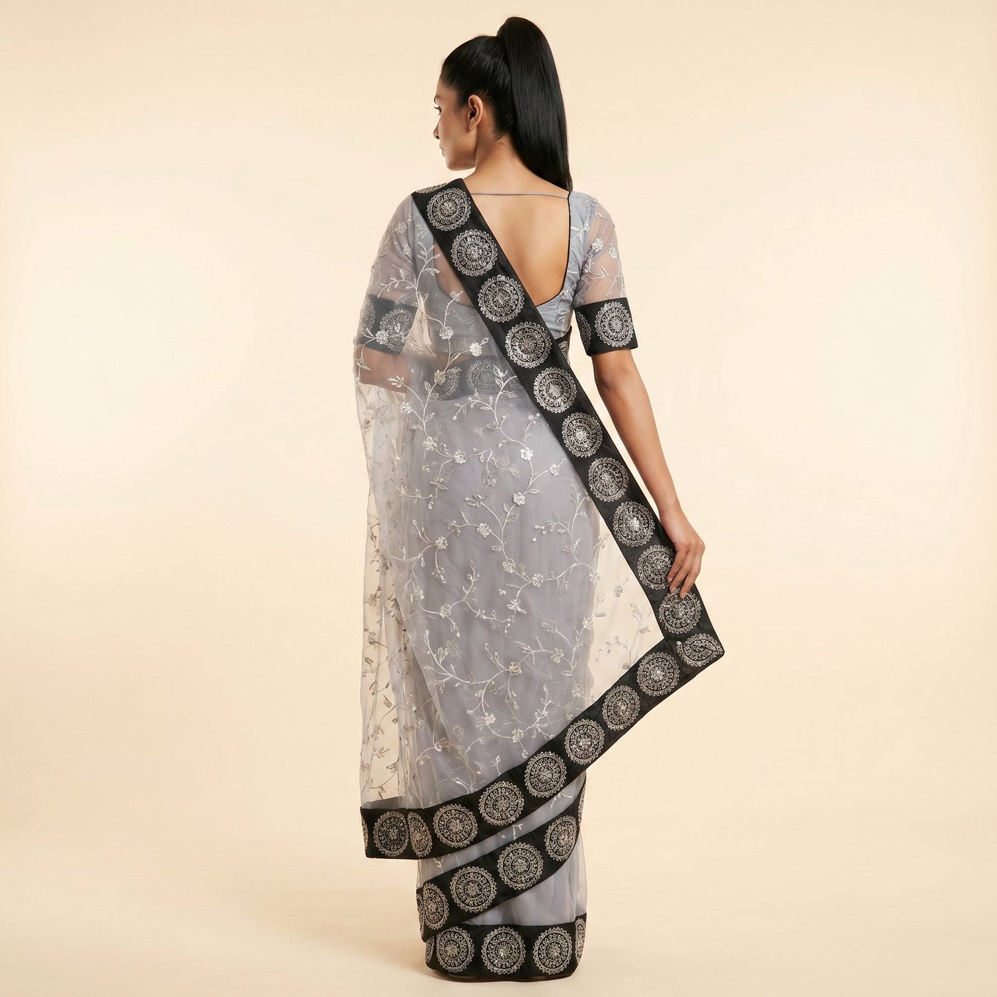 Graceful Grey Black Net Embroidered Saree on model - back