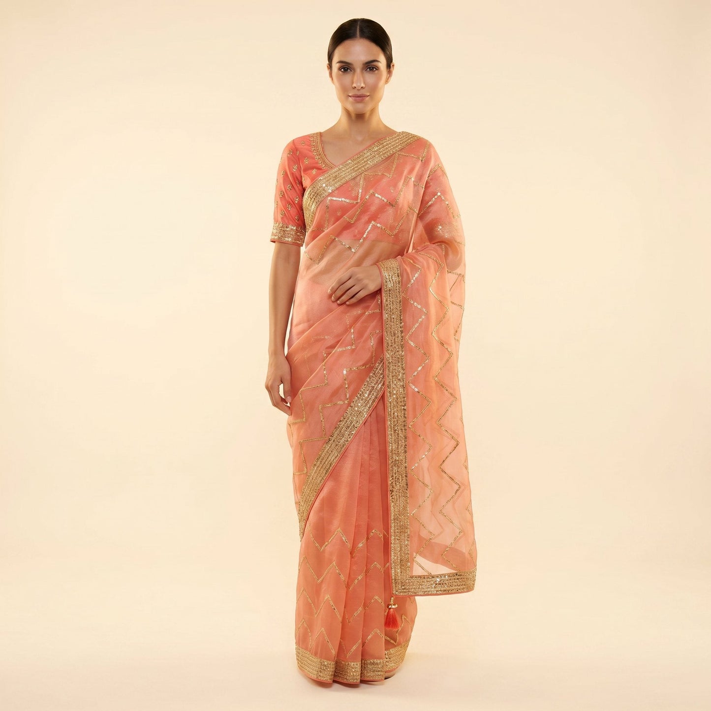 Peach-coral organza shimmer saree on model - front