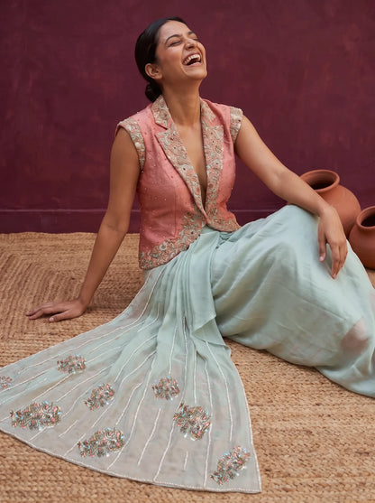 Mint green and peach orange skirt-jacket set, seated, palla embroidery