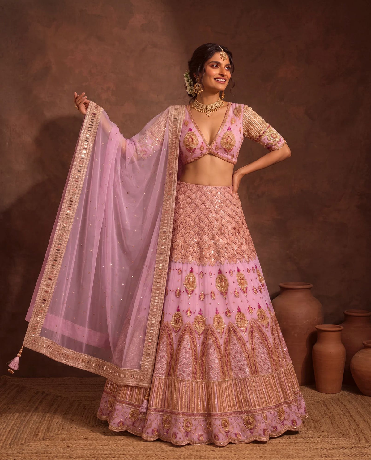 Pastel pink lehenga, dupatta held open