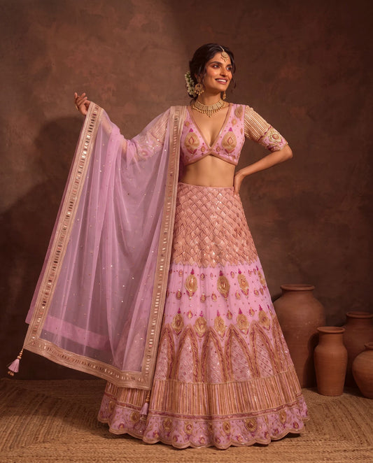 Pastel pink lehenga, dupatta held open